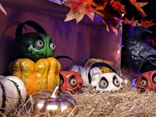 a group of mini pumpkins in a miniature pumpkin patch display